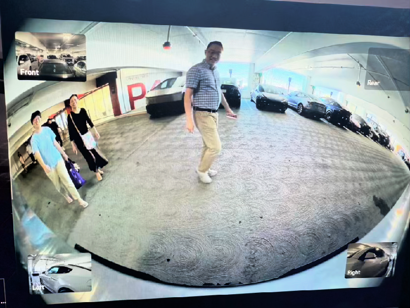 Tesla Sentry Mode capture — people in outdoor parking lot reacting to Big Nutz